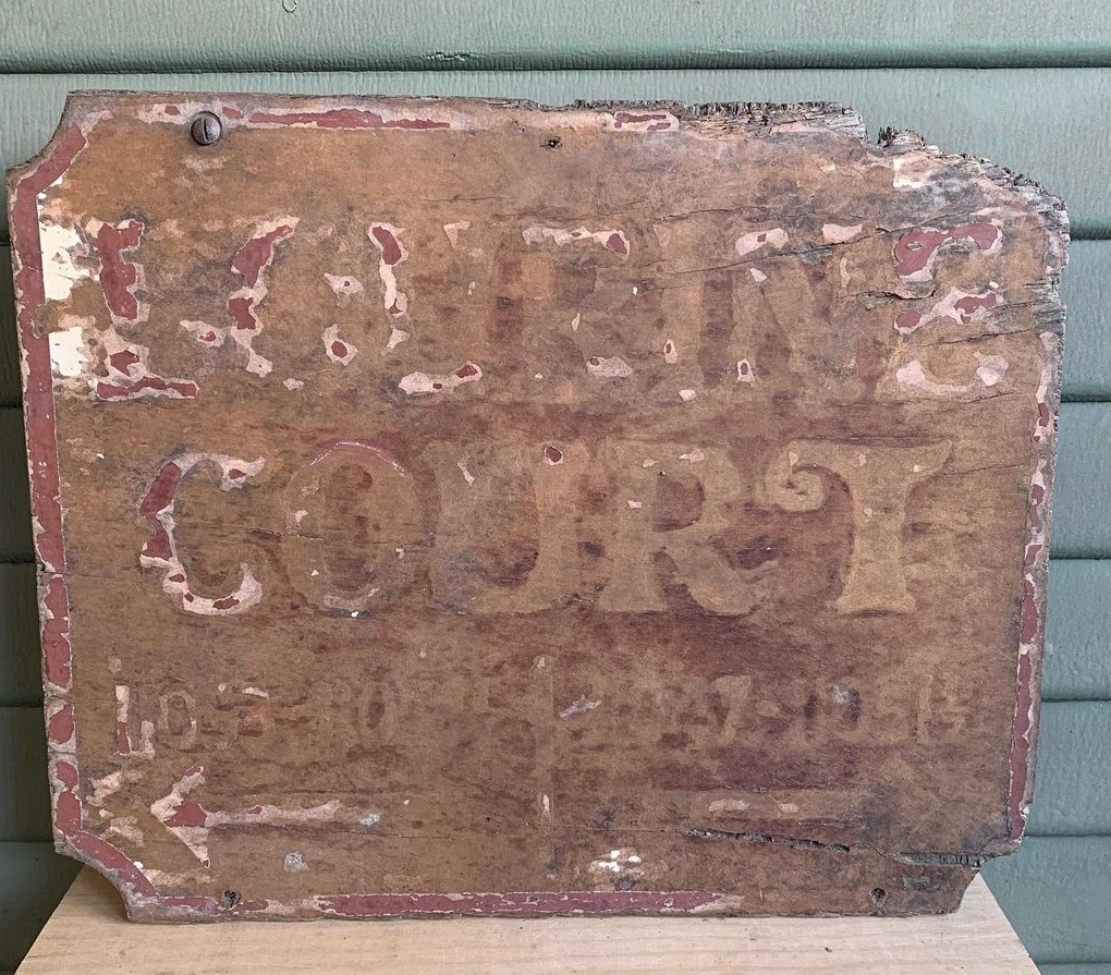 Original 1925 Lourine Court sign discovered by tenants in the greenspace