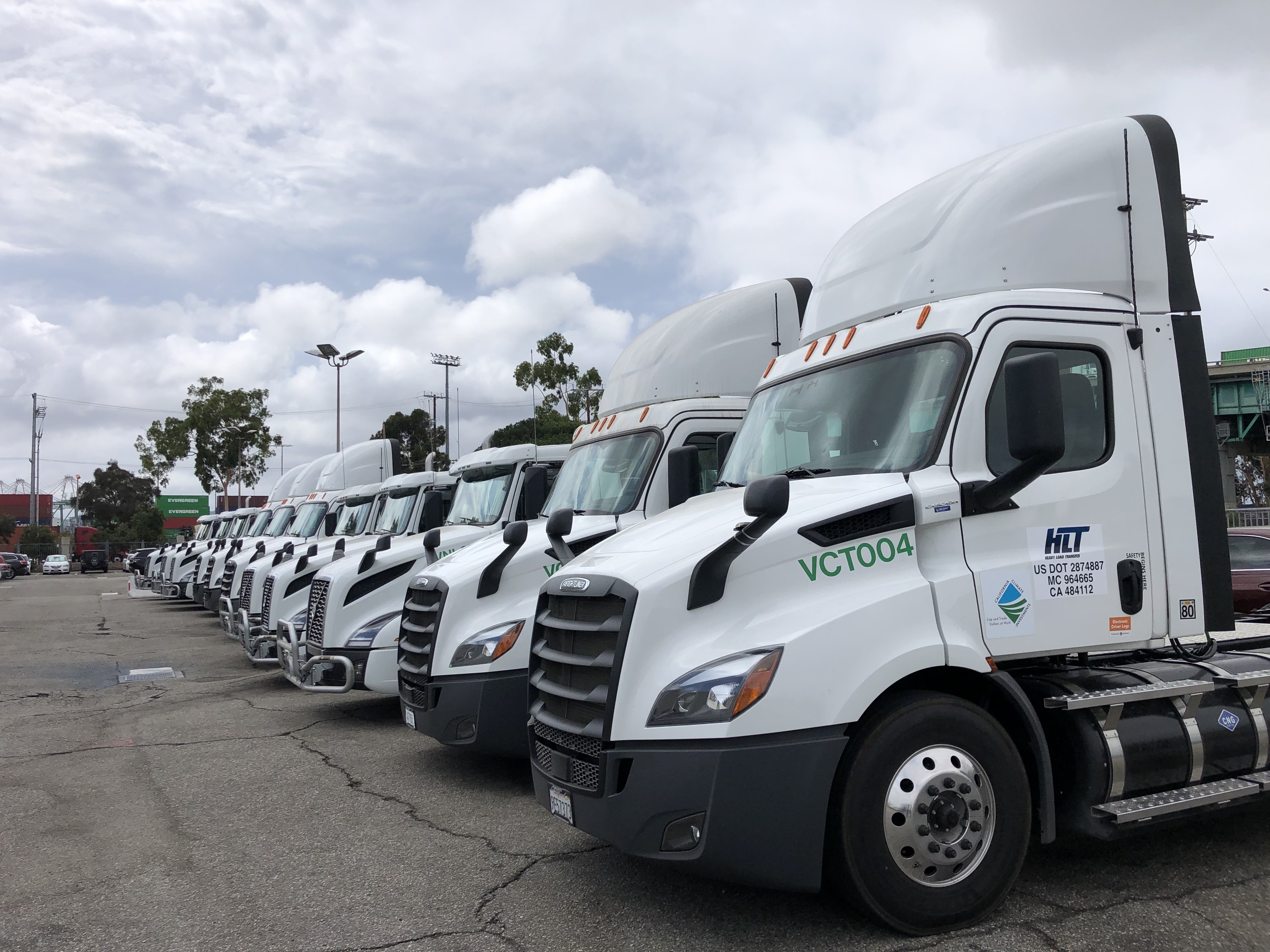 Image of electric heavy-duty trucks lined in a row